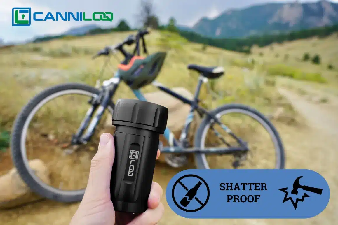 a black canniloq shatter proof and smell proof container shown on a mountain bike trail
